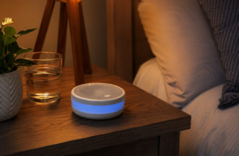 HoMedics SoundSleep white noise machine with blue glow on wooden nightstand