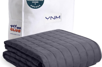 YnM weighted blanket with cooling glass beads on bed