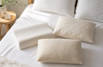 Different pillows arranged on white bedding - memory foam, shredded foam, and wool, in soft morning light