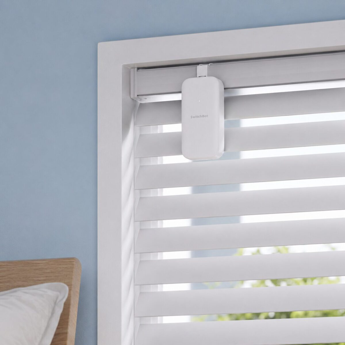 SwitchBot Blind Tilt device on horizontal blinds in bedroom