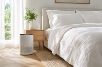 Allergy friendly bedroom with white bedding and a small air purifier near the bed